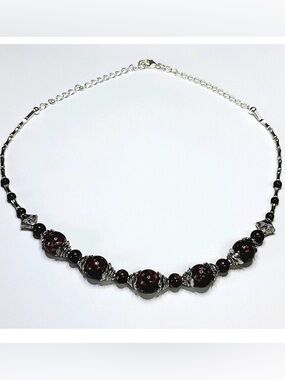 Hand crafted Necklace with 1 cm round speckled glass beads 18" long.